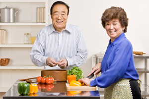 couple-with-vegetables-on-counter